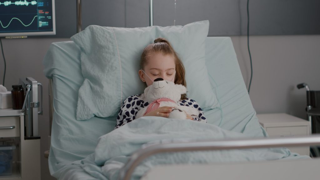 Portrait of tired sick child sleeping after suffering medical recovery surgery